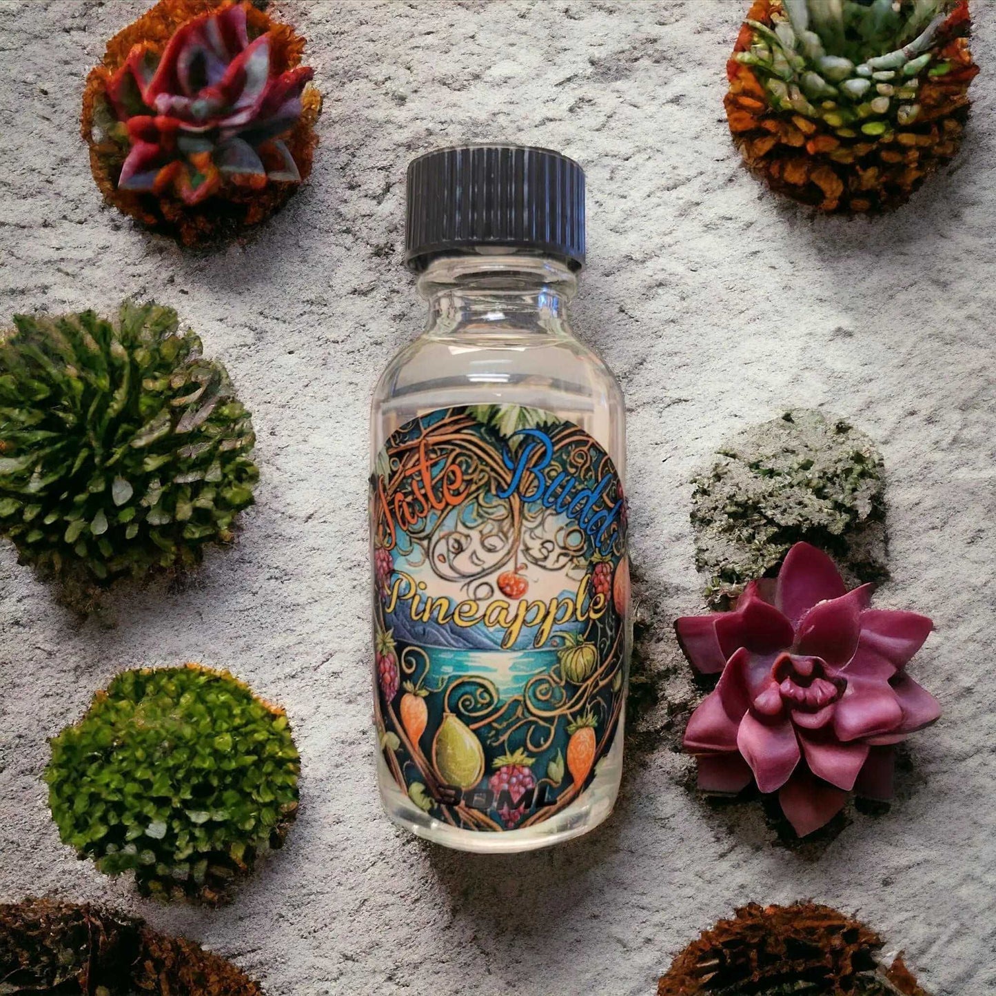 Taste Budds Pineapple - 30mL Natural Flavor in a glass bottle surrounded by decorative succulents.