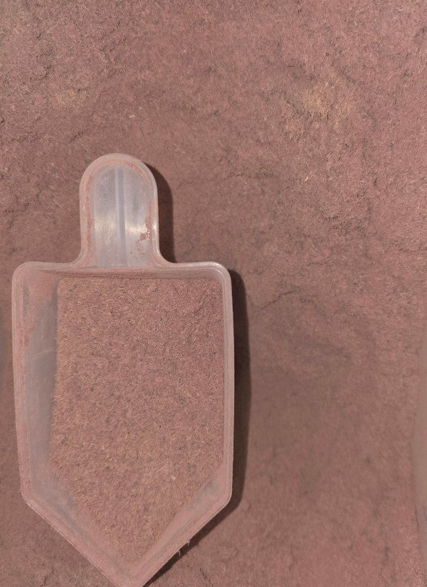 Scoop of Mimosa Hostilis Inner Root Bark powder for organic dye