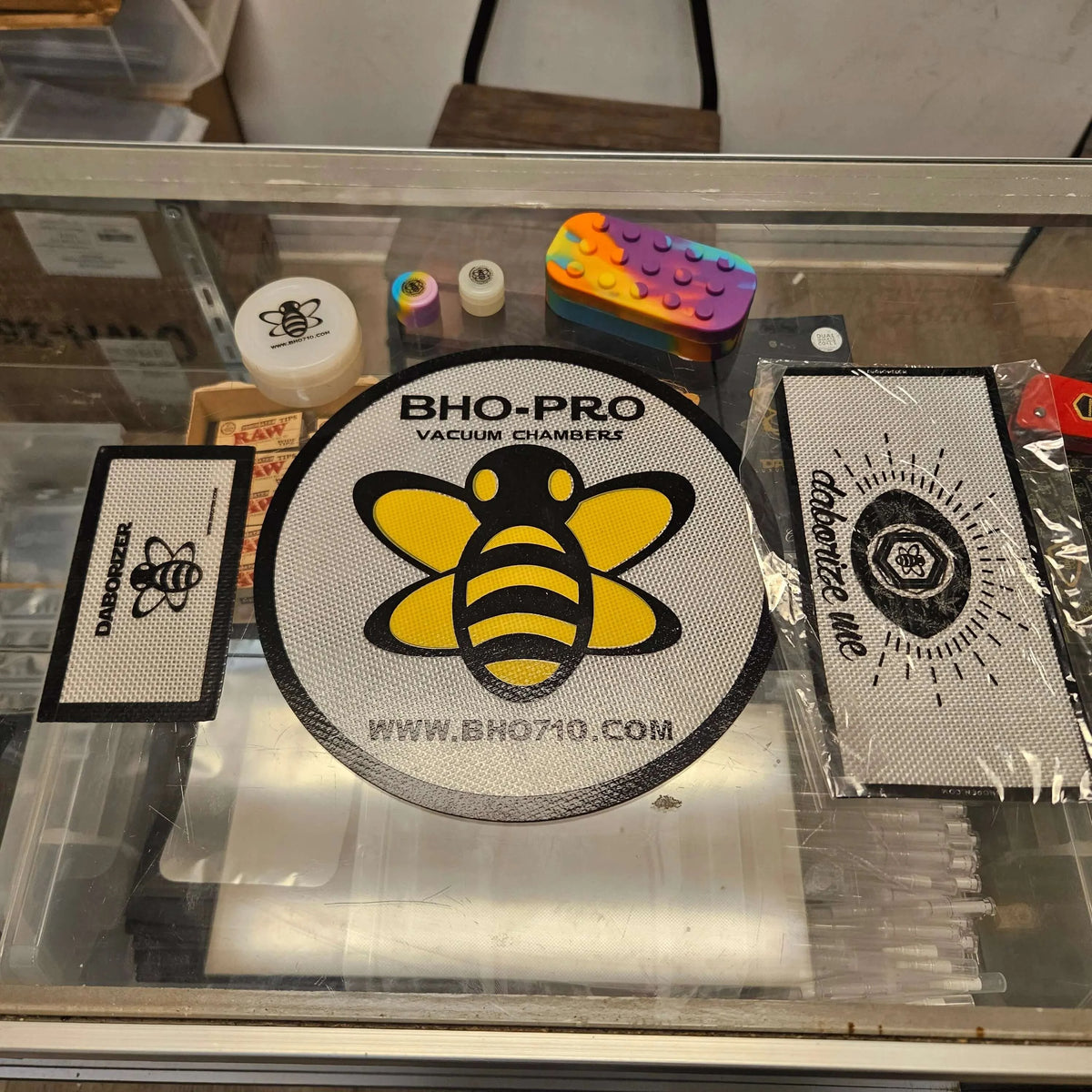 Display of silicone containers from Platinum Cured Silicone Concentrate Kit with colorful designs and branding.